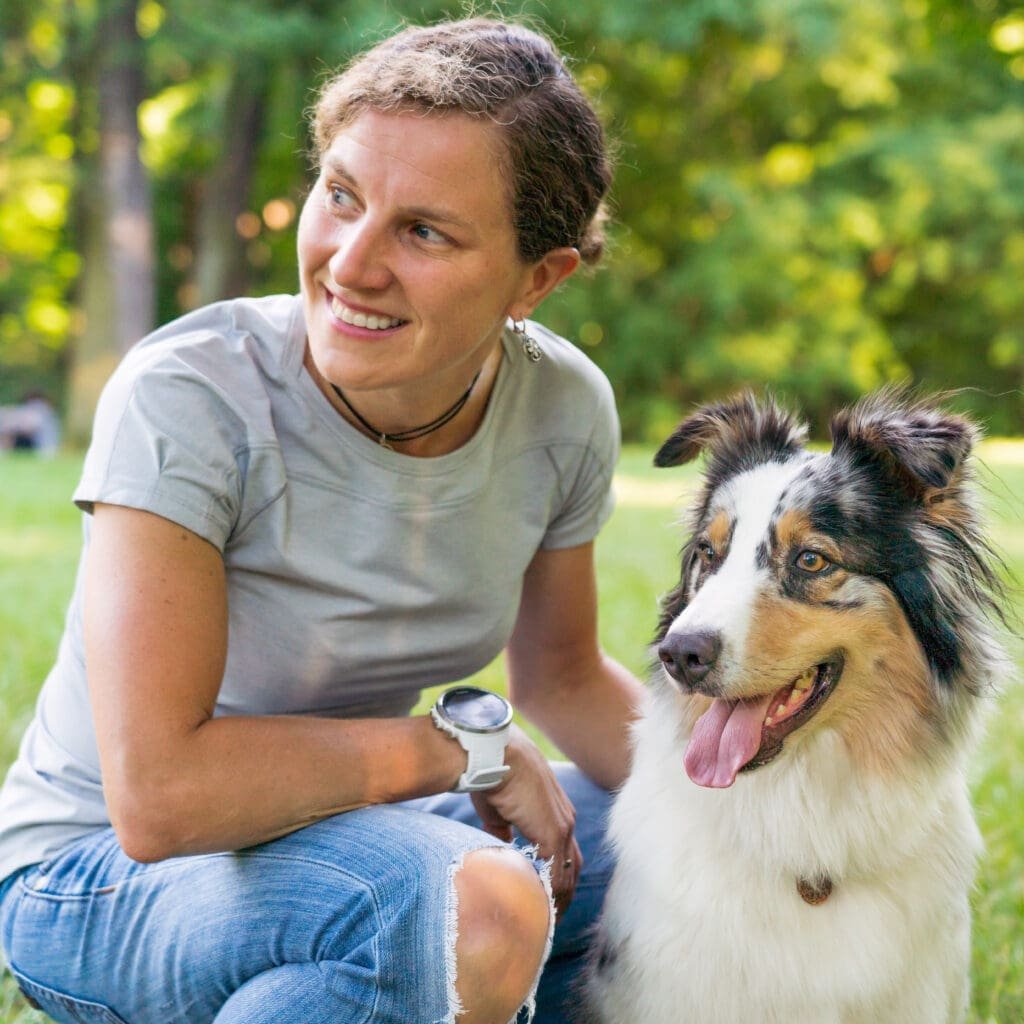 Happy woman spending time with lovely australian shepard